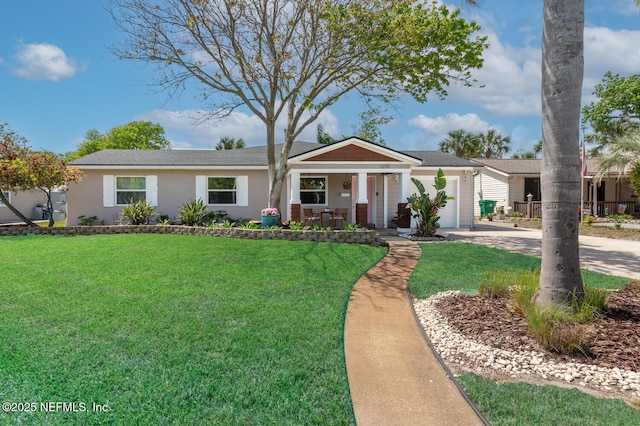 1018 14th Ave N, Jacksonville Beach, FL 32250 - ranch-style house with covered porch, a garage, concrete driveway, and a front lawn