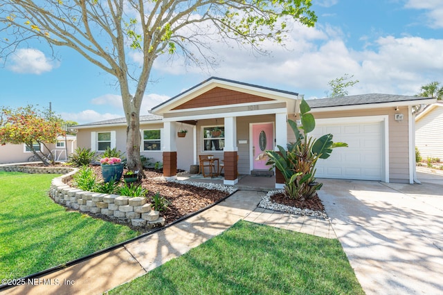 1018 14th Ave N, Jacksonville Beach, FL 32250 - view of front of home featuring a front yard, a porch, a garage, and concrete driveway