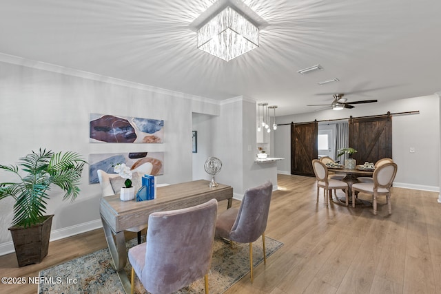 1018 14th Ave N, Jacksonville Beach, FL 32250 - dining area with light wood-style floors, an inviting chandelier, ornamental molding, a barn door, and baseboards