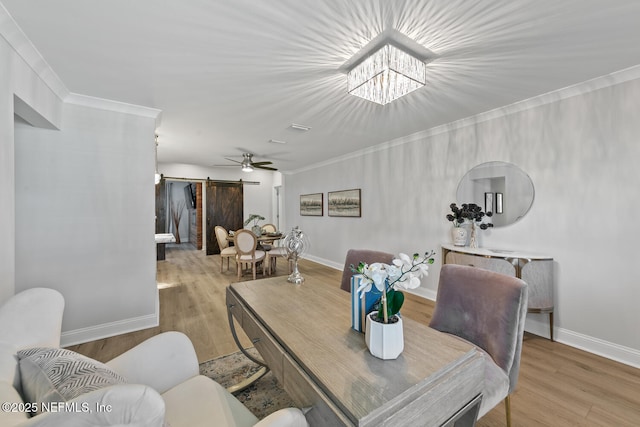 1018 14th Ave N, Jacksonville Beach, FL 32250 - dining room with a barn door, baseboards, and wood finished floors