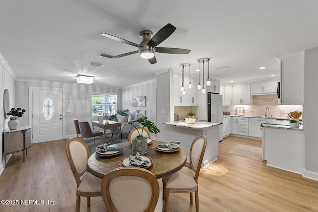 1018 14th Ave N, Jacksonville Beach, FL 32250 - dining room featuring light wood-style floors, ornamental molding, a ceiling fan, and recessed lighting