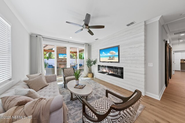 1018 14th Ave N, Jacksonville Beach, FL 32250 - living area featuring crown molding, visible vents, and a glass covered fireplace