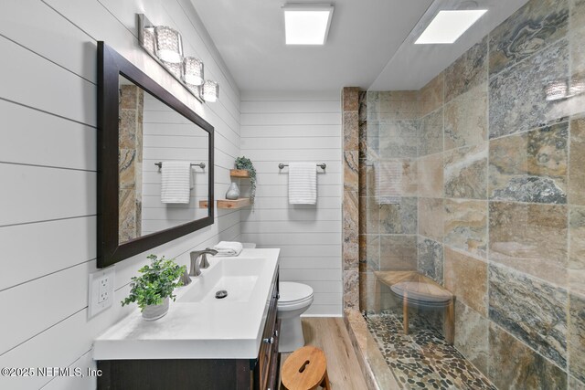 1018 14th Ave N, Jacksonville Beach, FL 32250 - full bathroom featuring toilet, a walk in shower, vanity, and wood finished floors