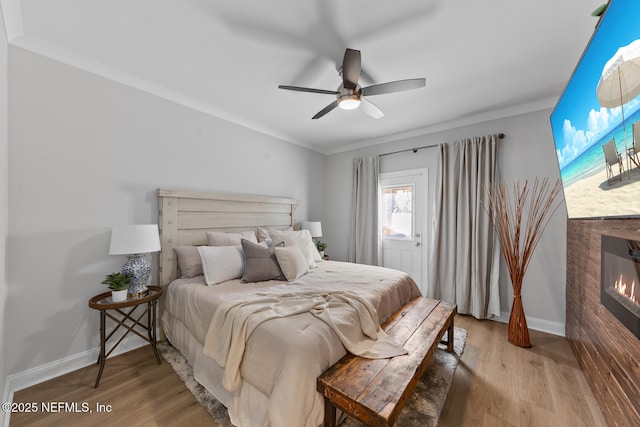 1018 14th Ave N, Jacksonville Beach, FL 32250 - bedroom featuring a glass covered fireplace, ornamental molding, and wood finished floors