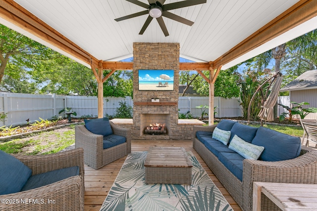 1018 14th Ave N, Jacksonville Beach, FL 32250 - view of patio / terrace with a fenced backyard, an outdoor living space with a fireplace, and a ceiling fan