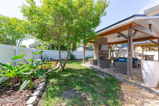 1018 14th Ave N, Jacksonville Beach, FL 32250 - view of yard featuring an outdoor living space with a fireplace, a fenced backyard, a ceiling fan, a patio, and a gazebo