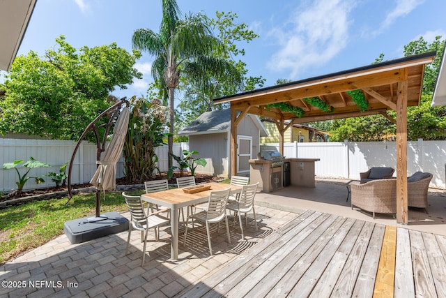 1018 14th Ave N, Jacksonville Beach, FL 32250 - view of patio featuring a shed, a fenced backyard, an outdoor structure, outdoor dining space, and a deck