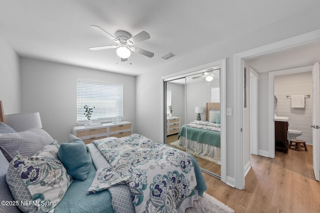 1018 14th Ave N, Jacksonville Beach, FL 32250 - bedroom featuring light wood finished floors, a closet, baseboards, and a ceiling fan