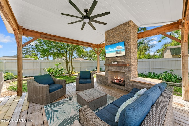 1018 14th Ave N, Jacksonville Beach, FL 32250 - wooden deck featuring a fenced backyard, an outdoor living space with a fireplace, and a ceiling fan