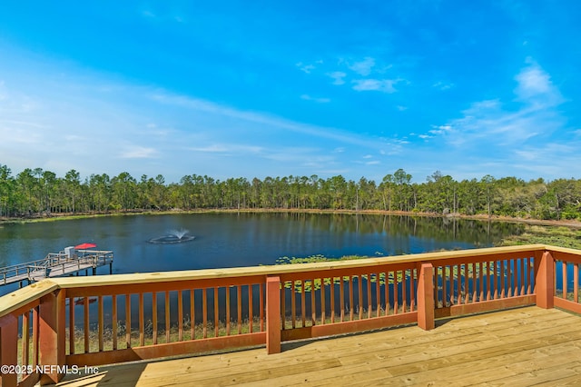 wooden deck with a water view and a forest view
