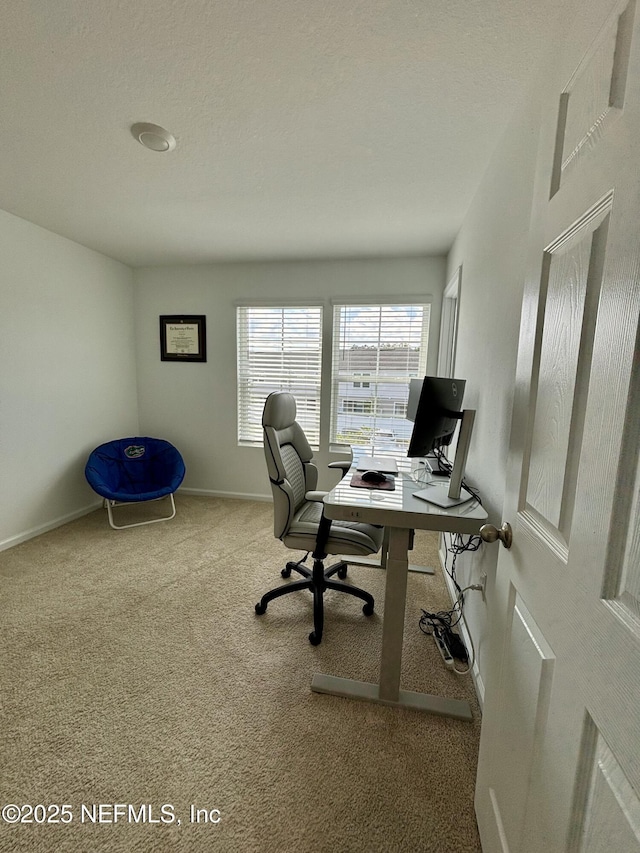 carpeted office space featuring baseboards