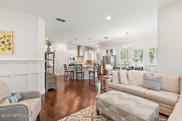 225 Garden Wood Dr, Ponte Vedra, FL 32081 - living area featuring visible vents, a notable chandelier, dark wood-style flooring, a textured ceiling, and recessed lighting