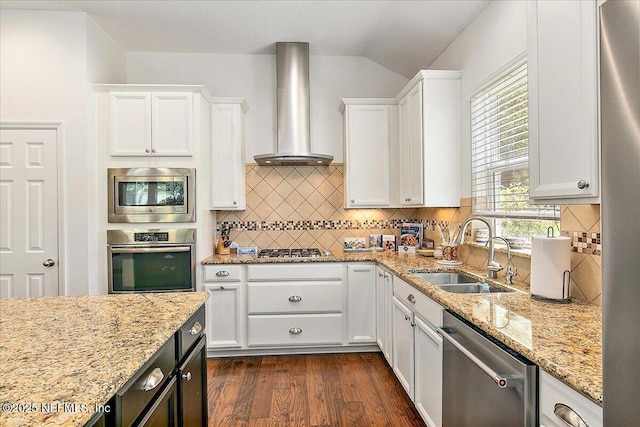 225 Garden Wood Dr, Ponte Vedra, FL 32081 - kitchen with wall chimney exhaust hood, a sink, appliances with stainless steel finishes, dark wood finished floors, and white cabinetry