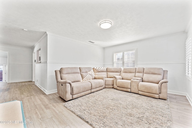 8871 Manson Cir, Jacksonville, FL 32220 - living area with light wood-style floors, crown molding, a textured ceiling, visible vents, and baseboards