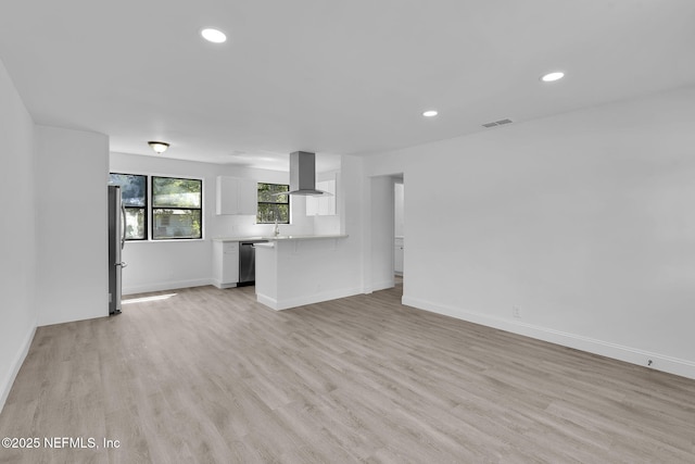 7427 Warner Dr, Jacksonville, FL 32244 - unfurnished living room with recessed lighting, light wood-style flooring, and baseboards