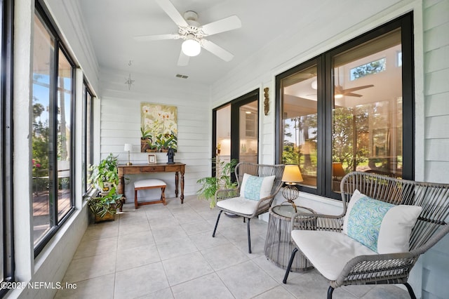 sunroom with a ceiling fan