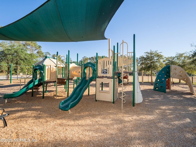 community jungle gym featuring fence