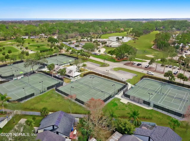aerial perspective of suburban area featuring a golf course and a large body of water