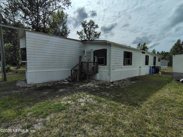 back of property featuring a lawn
