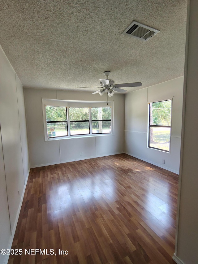 217 Pineway W Ave, Satsuma, FL 32189 - unfurnished room featuring wood finished floors, a textured ceiling, a ceiling fan, and baseboards
