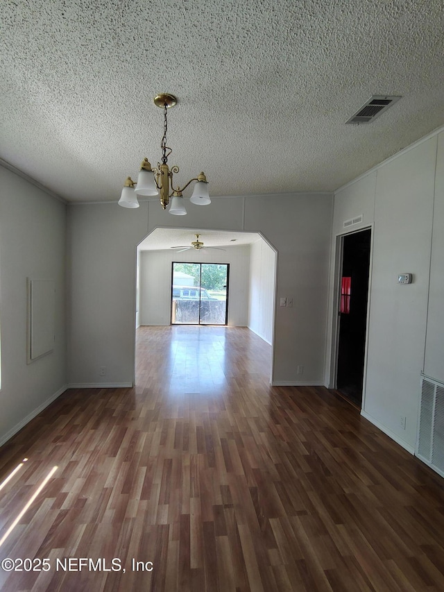 217 Pineway W Ave, Satsuma, FL 32189 - unfurnished room with a chandelier, a textured ceiling, arched walkways, and wood finished floors