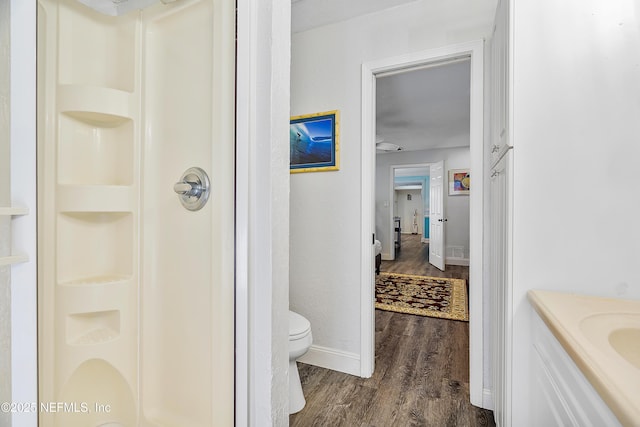 9 Blare Dr, Palm Coast, FL 32137 - bathroom featuring vanity, toilet, wood finished floors, walk in shower, and baseboards