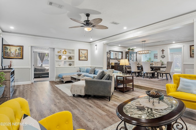 9 Blare Dr, Palm Coast, FL 32137 - living room featuring visible vents, ceiling fan, a wealth of natural light, and wood finished floors