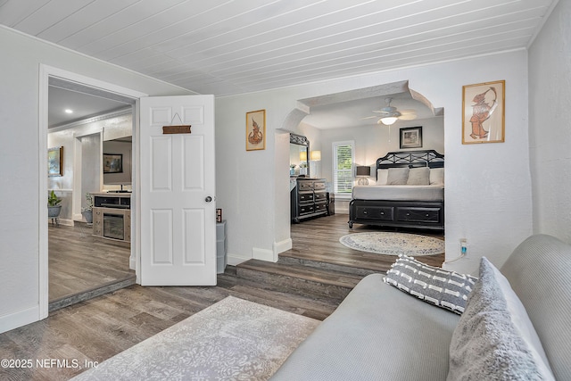 9 Blare Dr, Palm Coast, FL 32137 - bedroom featuring arched walkways, baseboards, a ceiling fan, and wood finished floors