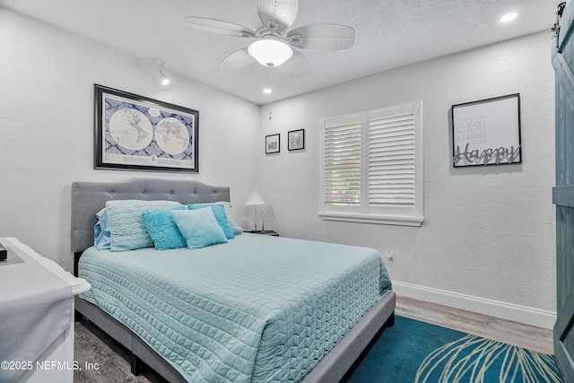 9 Blare Dr, Palm Coast, FL 32137 - bedroom featuring a textured ceiling, wood finished floors, a textured wall, and baseboards
