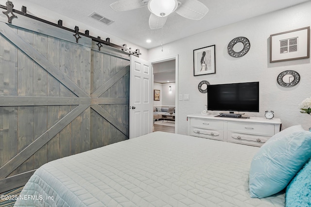 9 Blare Dr, Palm Coast, FL 32137 - bedroom featuring a ceiling fan, visible vents, and a barn door