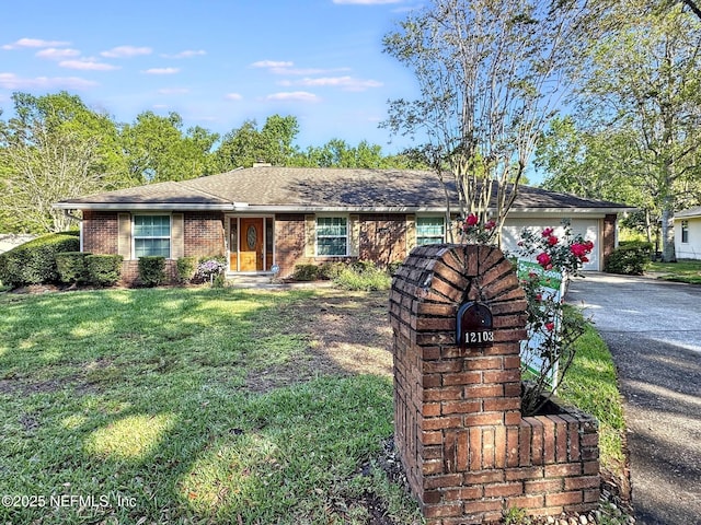ranch-style house with a front lawn, driveway, an attached garage, and brick siding