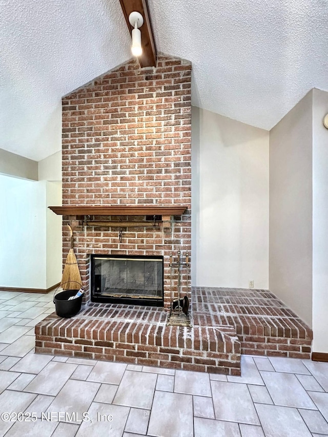interior details featuring beamed ceiling, a textured ceiling, and a fireplace