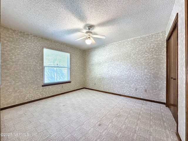 unfurnished bedroom featuring a ceiling fan, carpet floors, a textured ceiling, and a closet