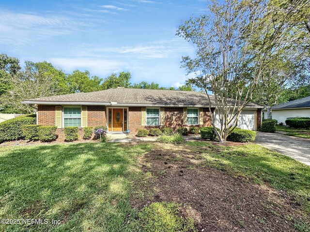 single story home with a front yard, an attached garage, aphalt driveway, and brick siding