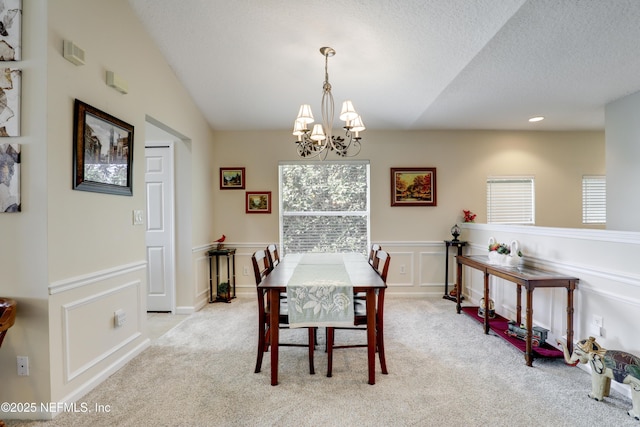 11929 Surfbird Cir Unit 12F, Jacksonville, FL 32256 - dining room featuring wainscoting, a textured ceiling, an inviting chandelier, and carpet floors