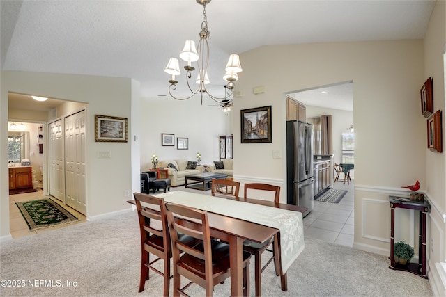 11929 Surfbird Cir Unit 12F, Jacksonville, FL 32256 - dining space featuring light tile patterned floors, light colored carpet, a notable chandelier, and vaulted ceiling