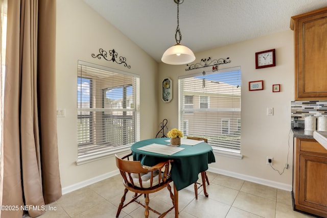 11929 Surfbird Cir Unit 12F, Jacksonville, FL 32256 - dining space with light tile patterned floors, baseboards, vaulted ceiling, and a textured ceiling