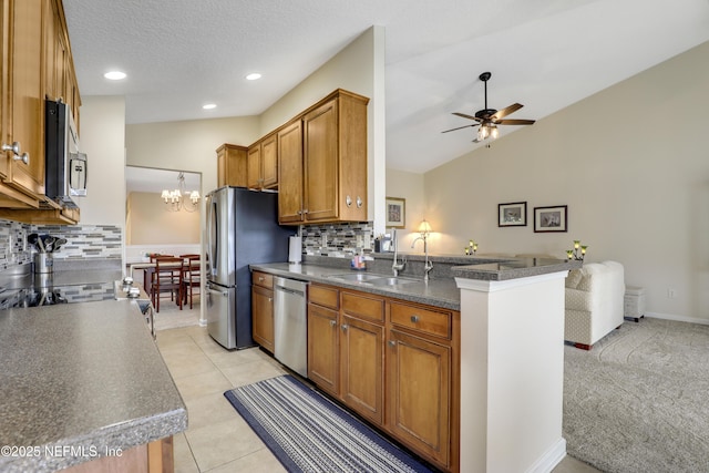 11929 Surfbird Cir Unit 12F, Jacksonville, FL 32256 - kitchen featuring dark countertops, a sink, backsplash, and stainless steel appliances