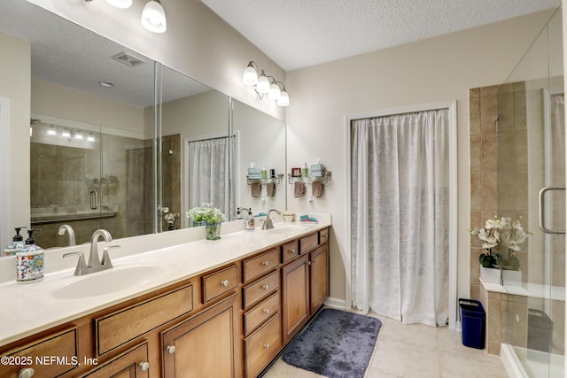 11929 Surfbird Cir Unit 12F, Jacksonville, FL 32256 - full bathroom featuring a shower stall, tile patterned floors, a textured ceiling, and a sink