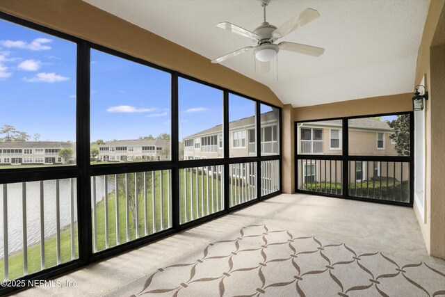 11929 Surfbird Cir Unit 12F, Jacksonville, FL 32256 - unfurnished sunroom with a water view, a residential view, carpet, and lofted ceiling