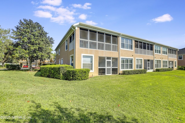 11929 Surfbird Cir Unit 12F, Jacksonville, FL 32256 - rear view of house with a yard and stucco siding