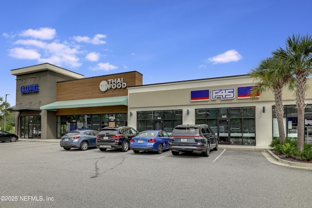 11929 Surfbird Cir Unit 12F, Jacksonville, FL 32256 - view of building exterior featuring uncovered parking
