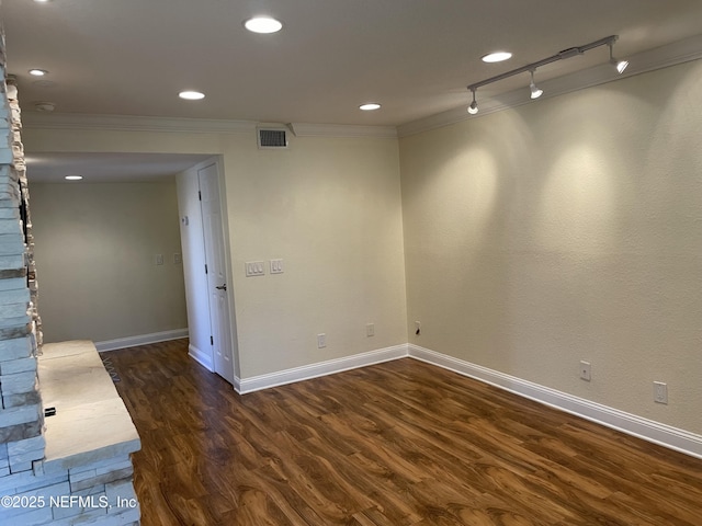 929 Seashell Ln, Ponte Vedra Beach, FL 32082 - empty room with crown molding, track lighting, baseboards, dark wood-type flooring, and visible vents
