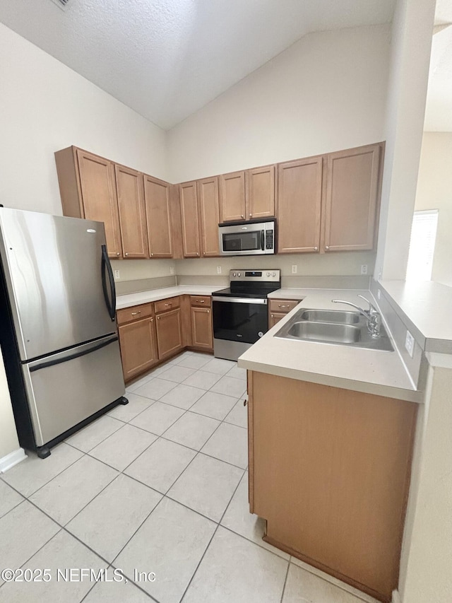 575 Oakleaf Plantation Pkwy Unit 412, Orange Park, FL 32065 - kitchen with light countertops, appliances with stainless steel finishes, light tile patterned floors, and a sink