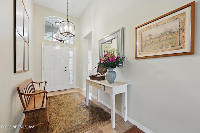 708 El Vergel Ln, Saint Augustine, FL 32080 - tiled entrance foyer with a high ceiling, a notable chandelier, and baseboards