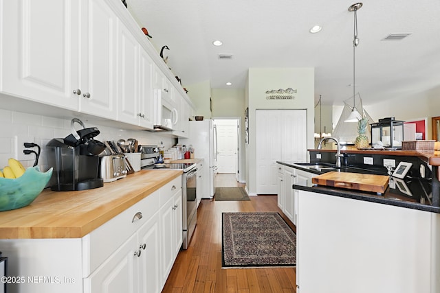 708 El Vergel Ln, Saint Augustine, FL 32080 - kitchen featuring visible vents, a sink, white appliances, butcher block counters, and backsplash