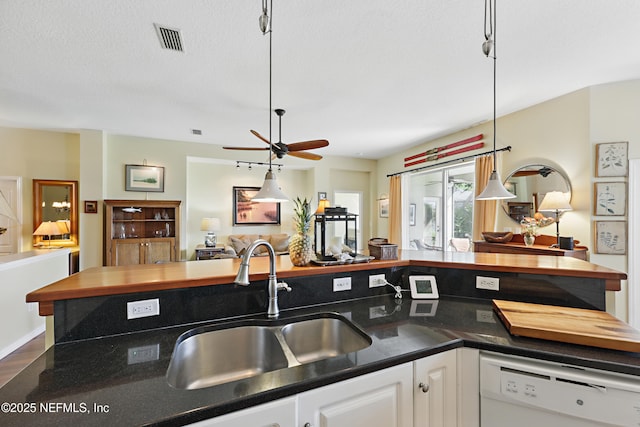708 El Vergel Ln, Saint Augustine, FL 32080 - kitchen with visible vents, a sink, dark countertops, white dishwasher, and open floor plan