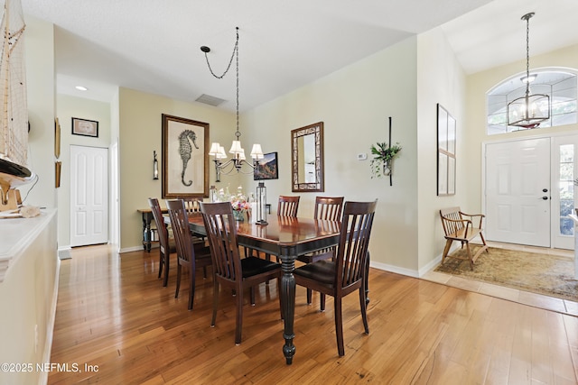 708 El Vergel Ln, Saint Augustine, FL 32080 - dining area featuring light wood finished floors, an inviting chandelier, baseboards, and visible vents