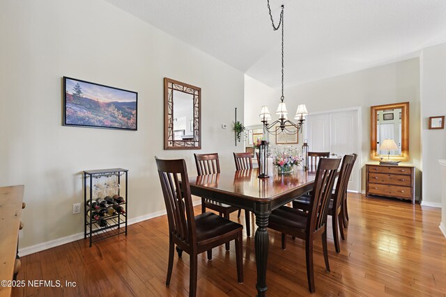 708 El Vergel Ln, Saint Augustine, FL 32080 - dining space featuring wood-type flooring, baseboards, and an inviting chandelier