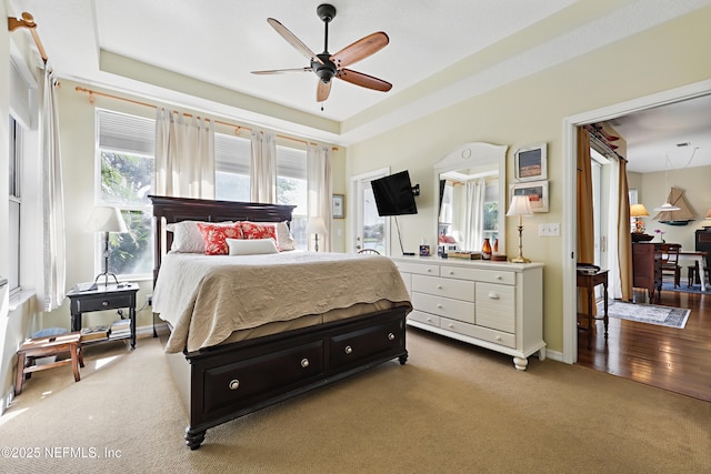 708 El Vergel Ln, Saint Augustine, FL 32080 - carpeted bedroom with a tray ceiling, baseboards, and ceiling fan